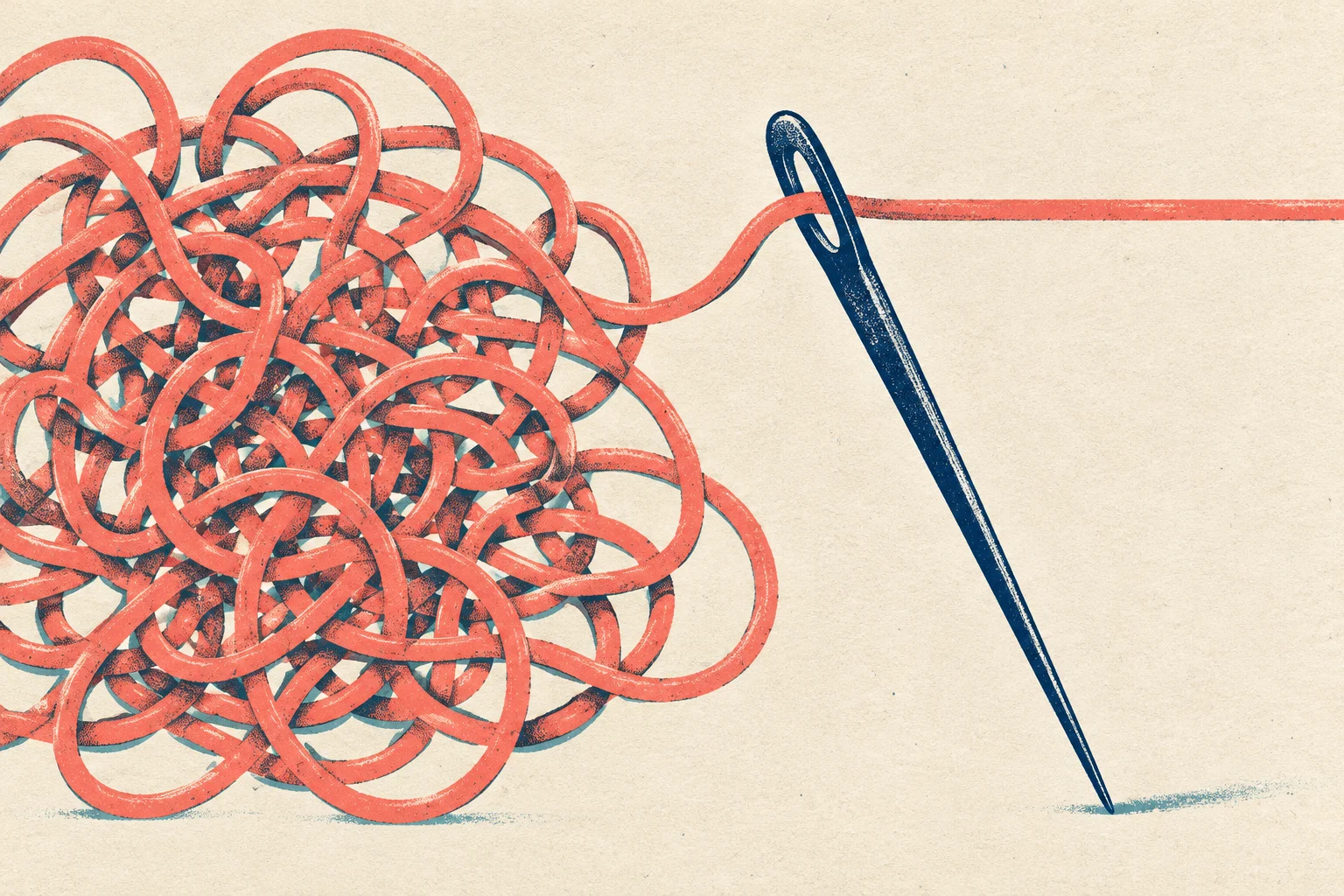 A tangled mass of coral thread on the left unwinds through the eye of a large navy sewing needle leaning diagonally against a cream background.