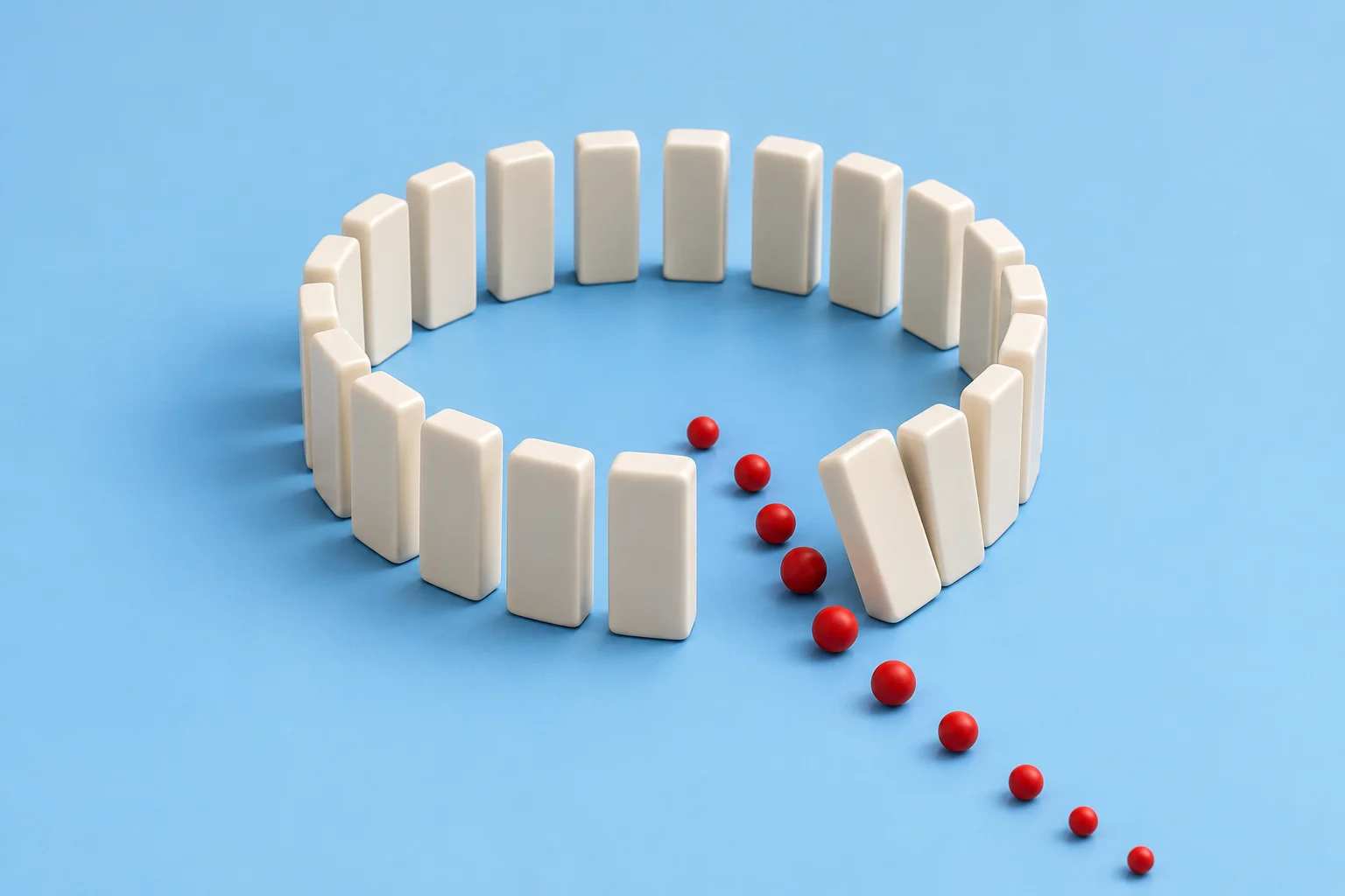 White dominoes form a circle on a blue surface, with one leaning beside a trail of red balls passing through a gap.